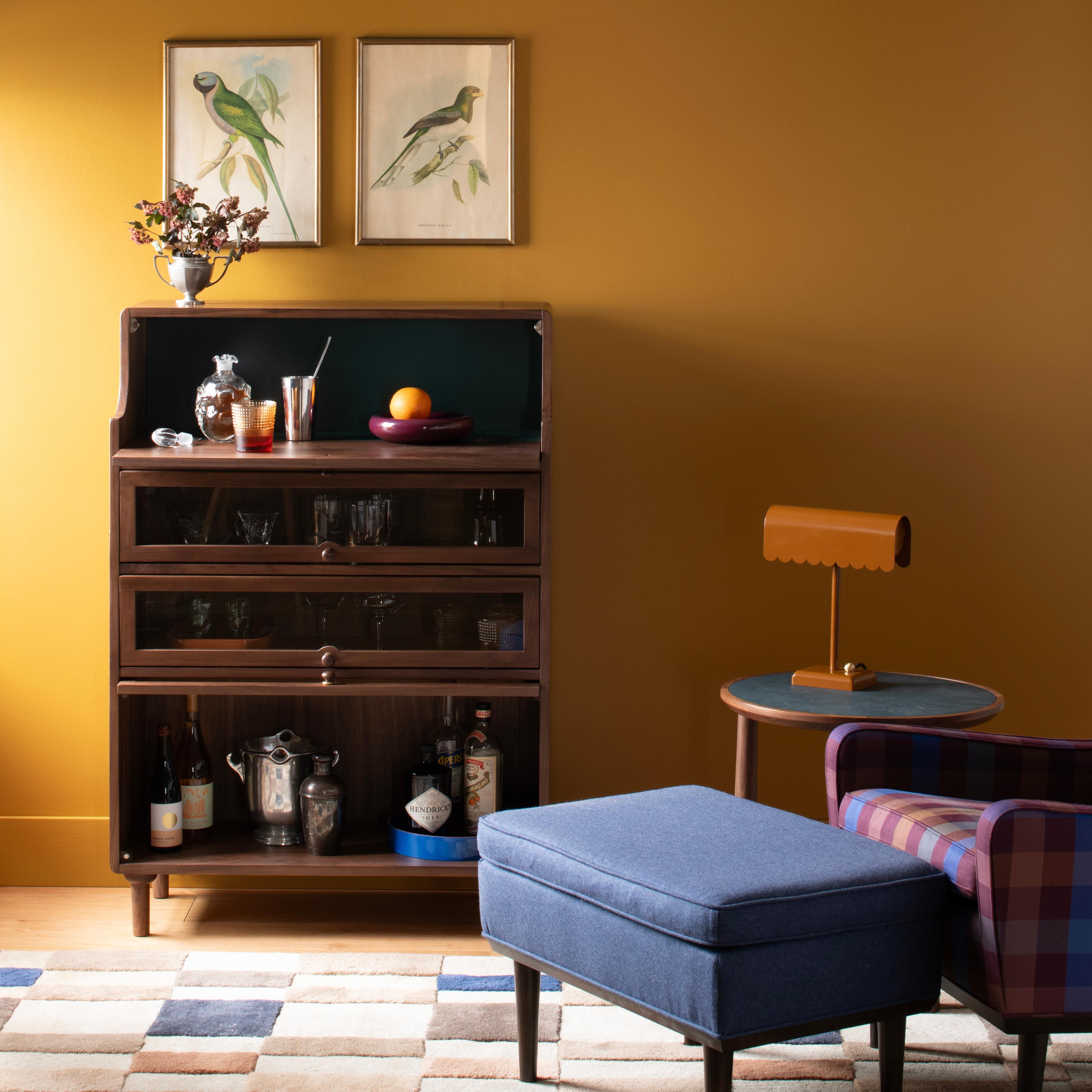 dark yellow room with curio cabinet